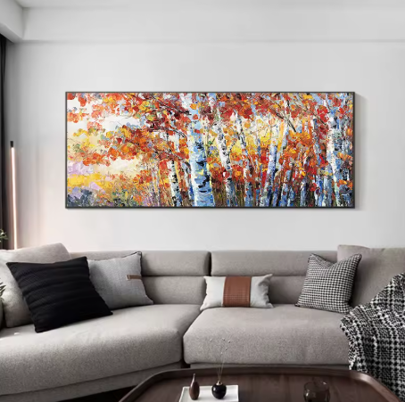 Abstract painting on a wall above a gray sofa in a living room.