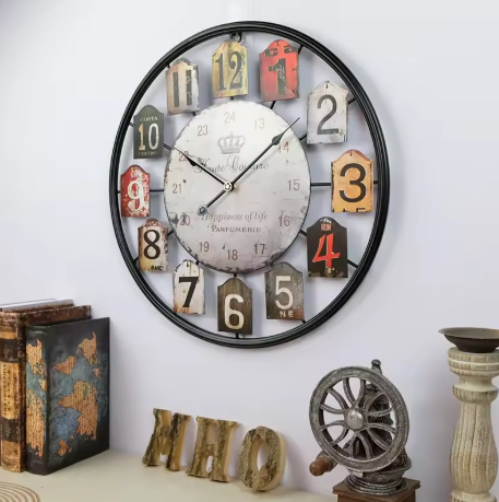 Decorative wall clock with vintage design on a white wall.