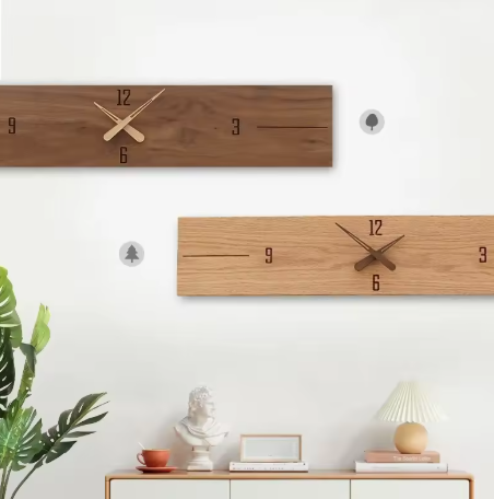 Two wooden wall clocks on a white wall with decorative items below.