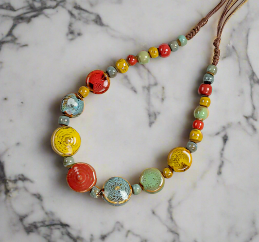 Colorful beaded necklace on a marble surface