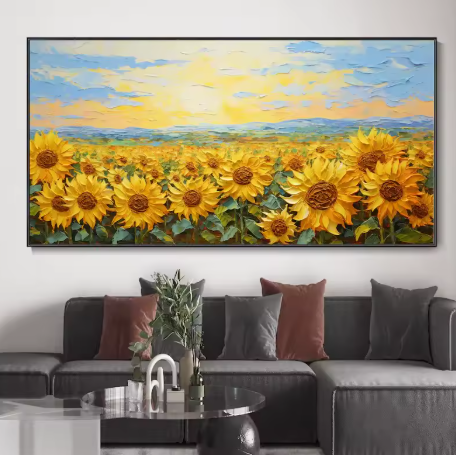 Framed painting of sunflowers above a gray sofa with colorful cushions.