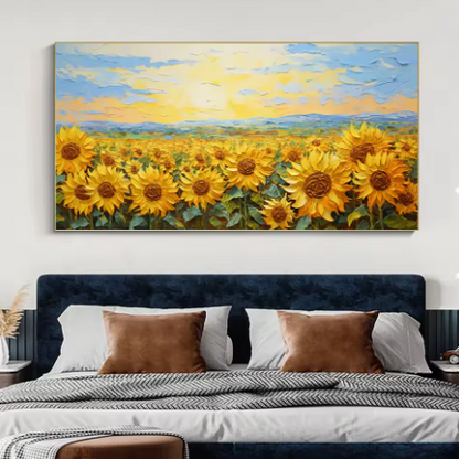 Painting of sunflowers on a wall above a bed with pillows.
