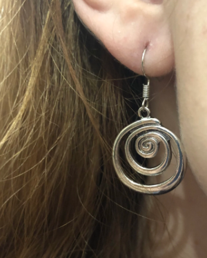 swirly earrings being worn