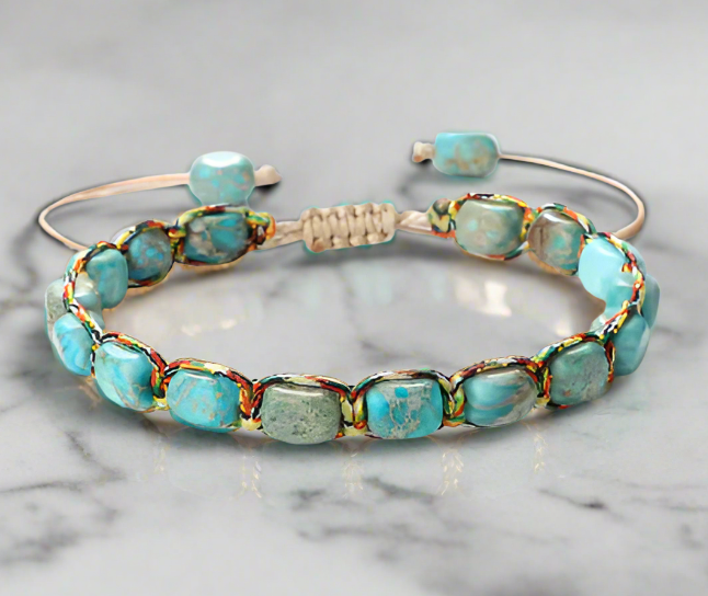 Turquoise beaded bracelet on a marble surface