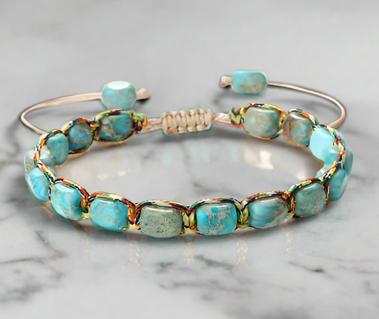 Turquoise beaded bracelet on a marble surface