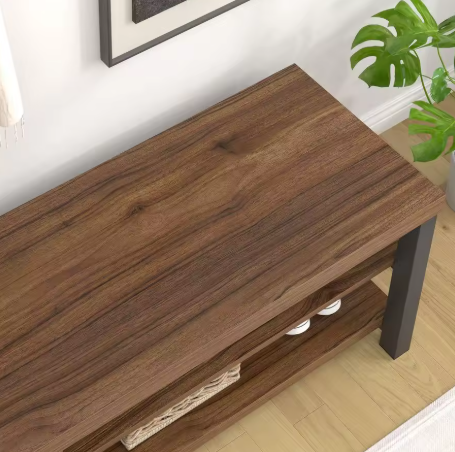 Wooden console table with a plant in the background