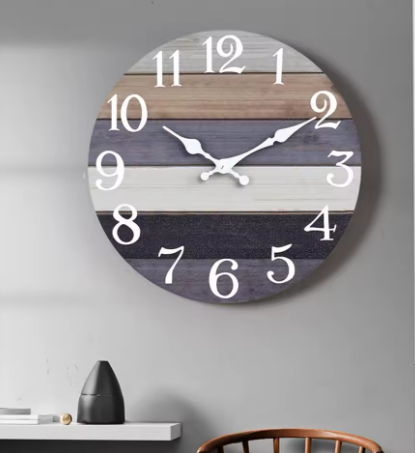 Round wall clock with wooden slat design on a gray wall