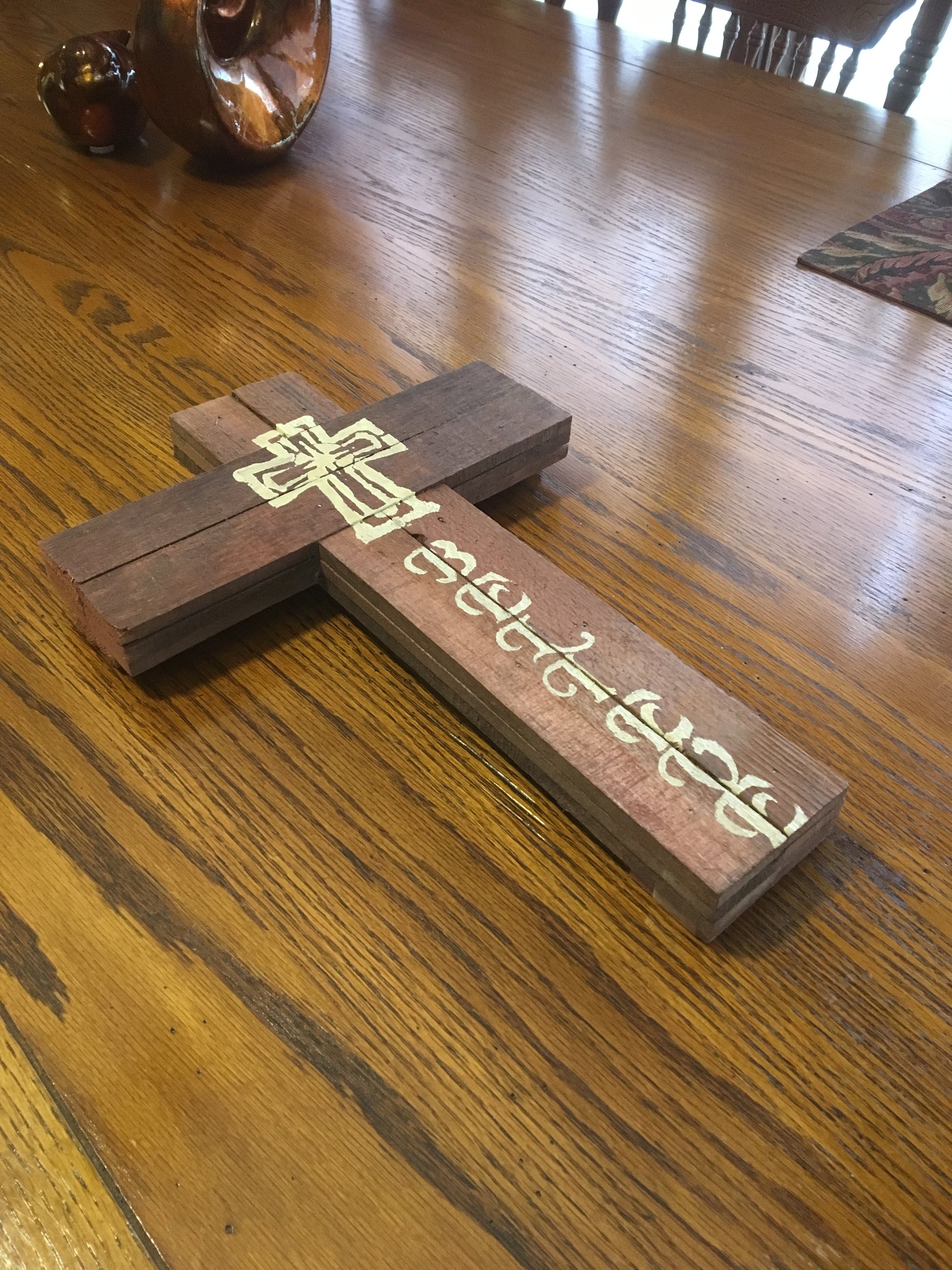 Pretty Believe wood sign on wood grain table
