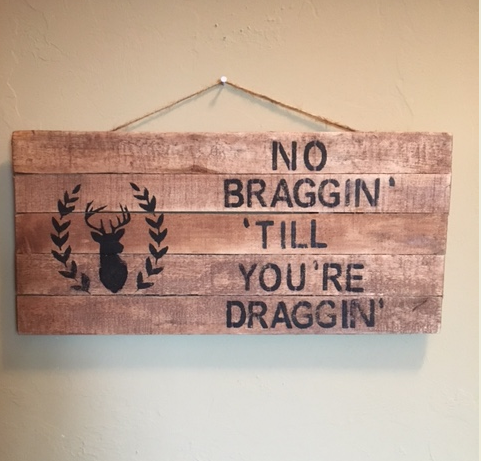 hunting pallet sign hanging on wall