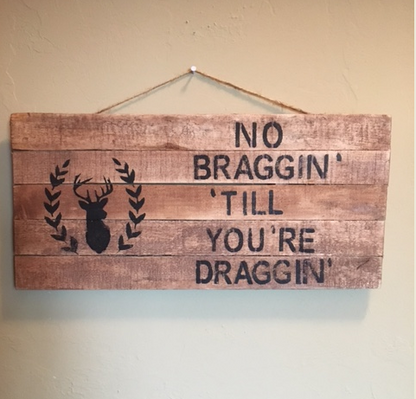hunting pallet sign hanging on wall