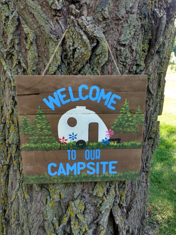 camping sign on tree