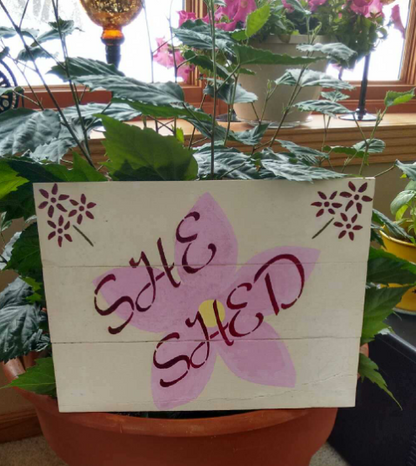 She Shed pallet sign on pot close up