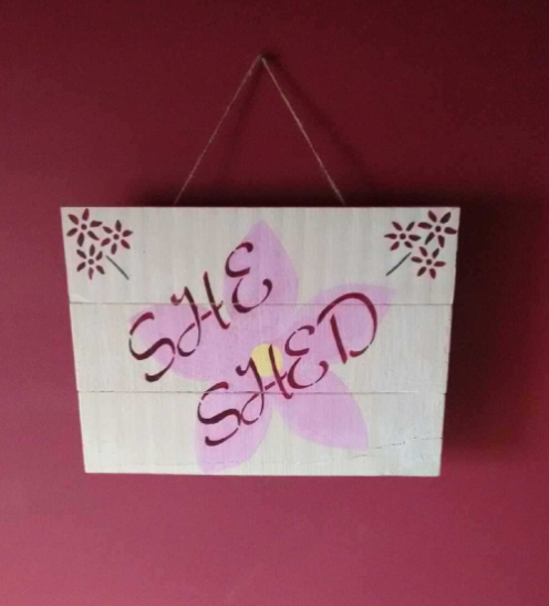 She Shed sign on pink wall