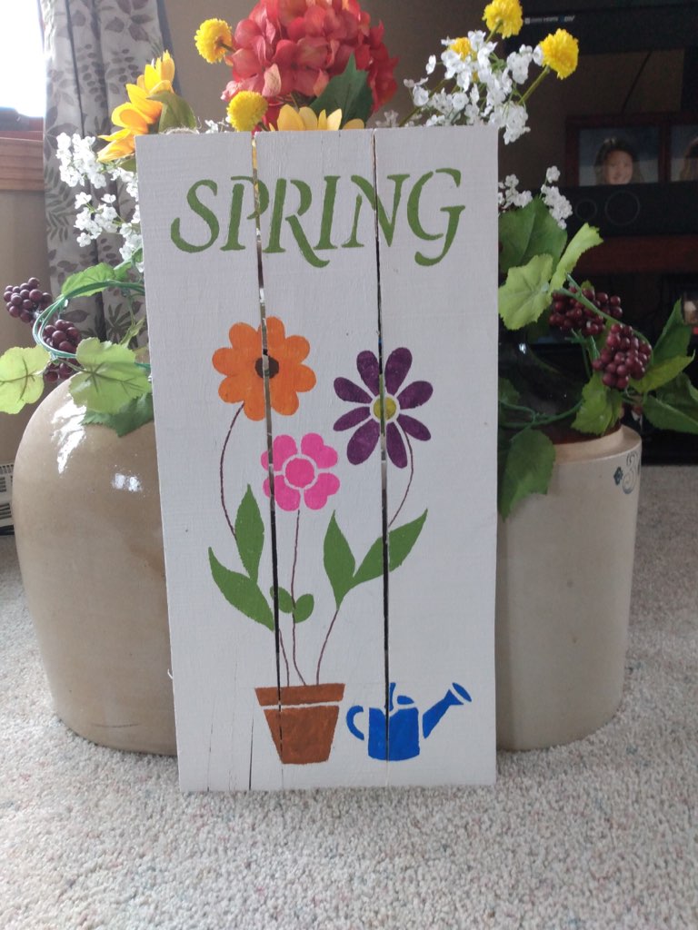 Spring pallet sign on floor in front of jug