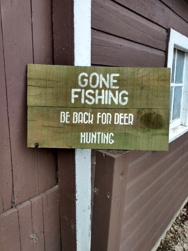 Gone fishing sign hanging on shed