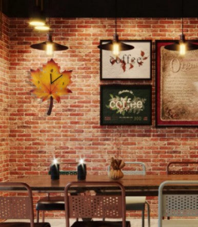 maple leaf clock hanging on brick wall