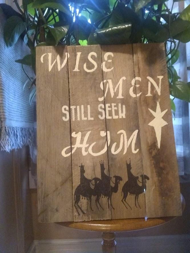 wise men pallet sign on table near pot